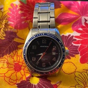 Armitron  is a men's silver-tone bracelet watch